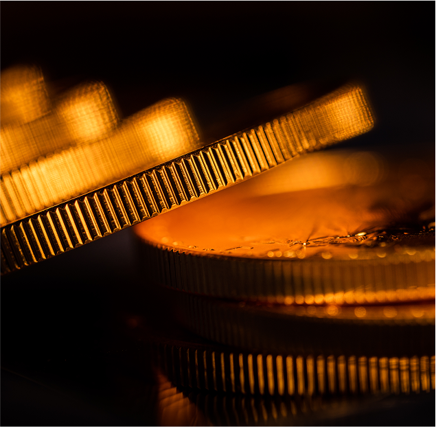 Up close image of gold coins falling over each other.