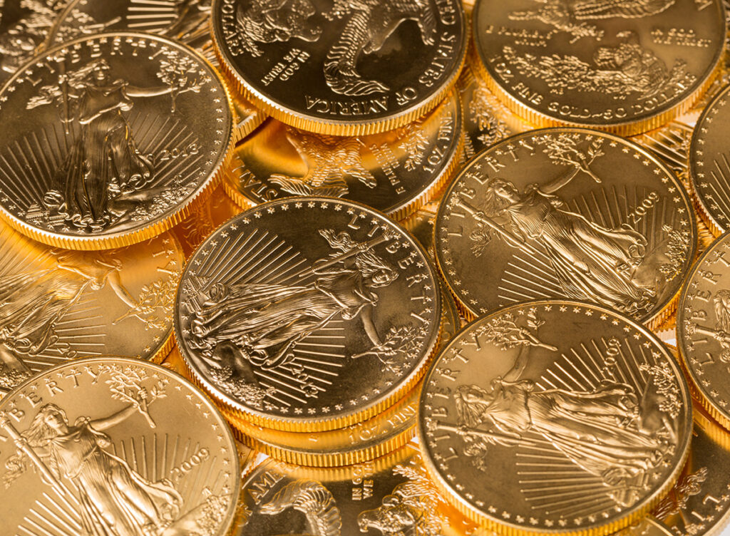 Gold bullion coins in a pile.